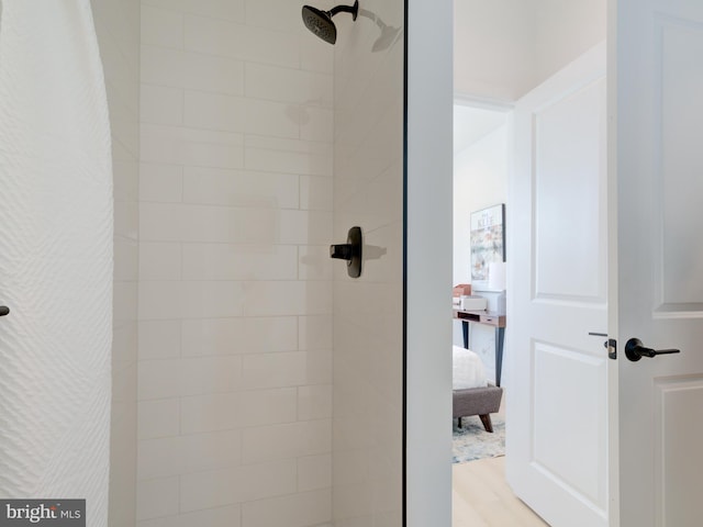 bathroom with hardwood / wood-style flooring and walk in shower