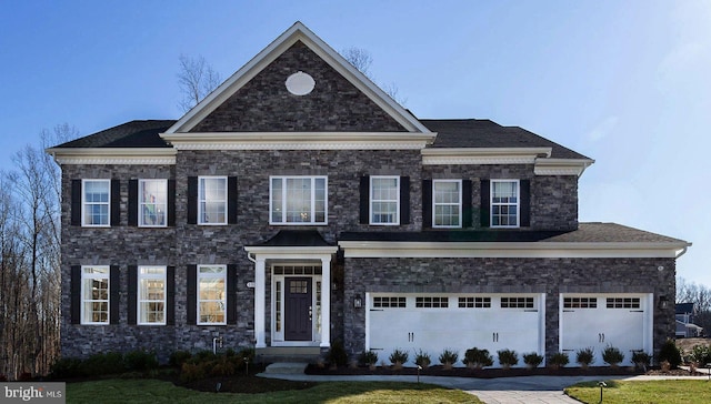 view of front facade with a front lawn and a garage