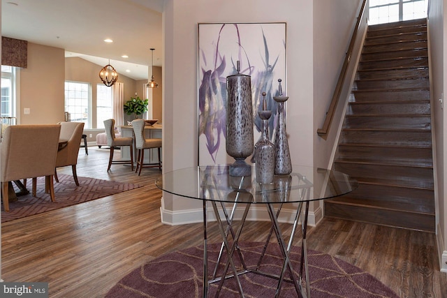 entrance foyer featuring a chandelier, hardwood / wood-style flooring, and vaulted ceiling