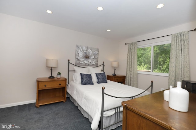 bedroom featuring dark carpet