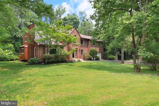 view of front of house with a garage and a front lawn