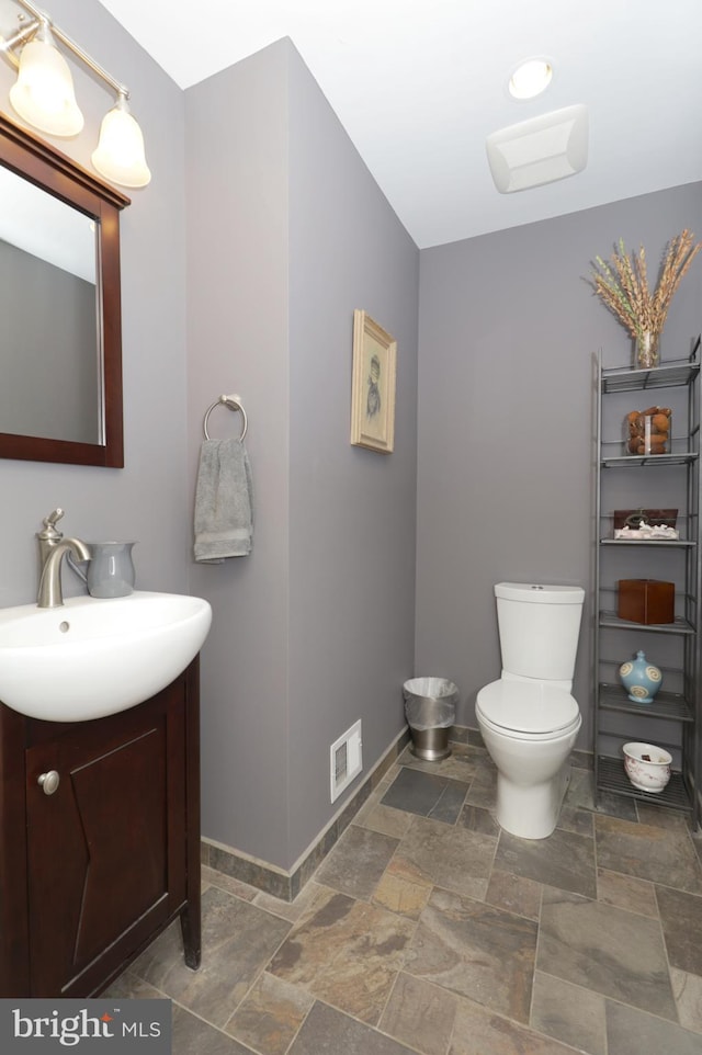 bathroom featuring vanity and toilet