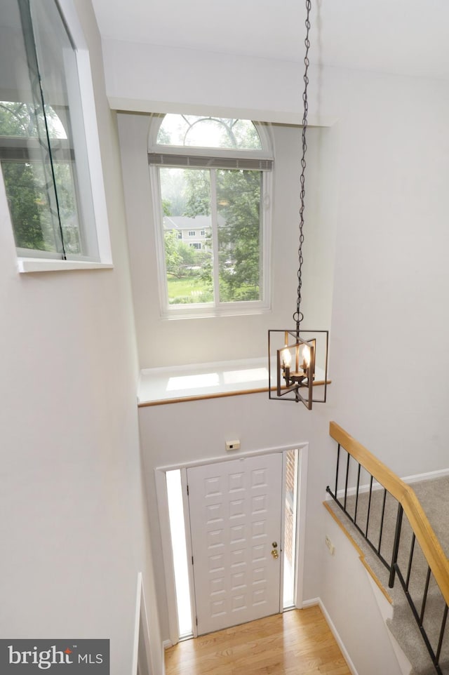 entrance foyer featuring light hardwood / wood-style flooring and a notable chandelier