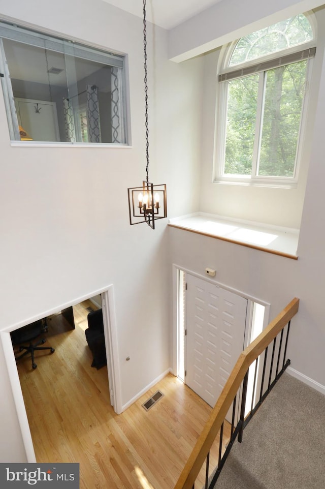 entrance foyer featuring wood-type flooring and an inviting chandelier