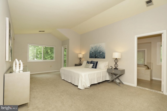 carpeted bedroom with lofted ceiling