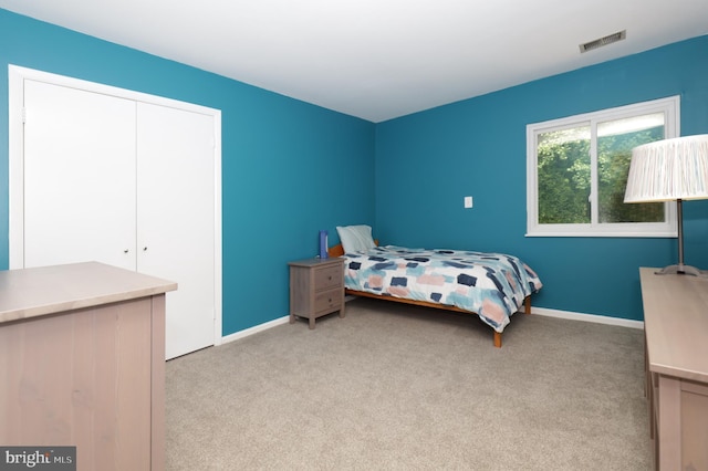 carpeted bedroom with a closet