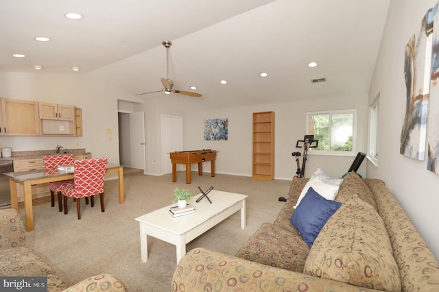 carpeted living room featuring vaulted ceiling and ceiling fan