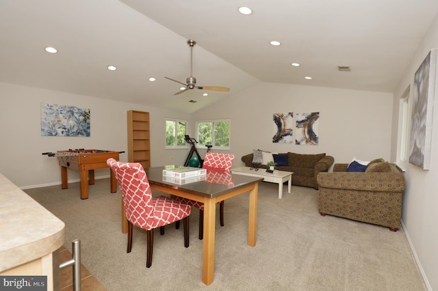 carpeted dining area featuring ceiling fan and lofted ceiling