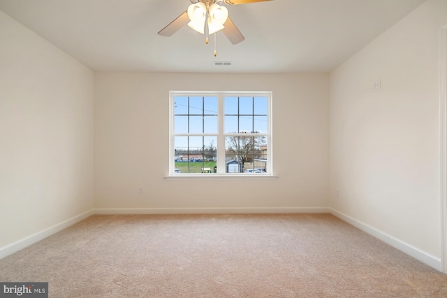 carpeted spare room featuring ceiling fan