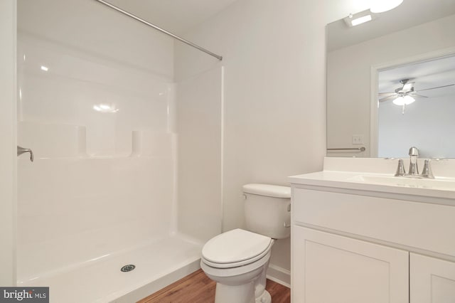 bathroom with walk in shower, ceiling fan, wood-type flooring, and toilet