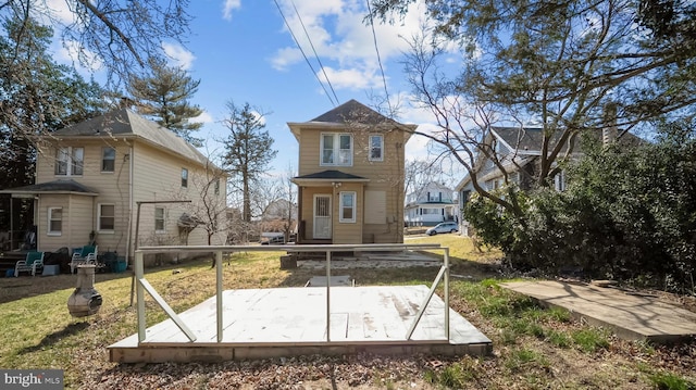 rear view of house featuring a lawn