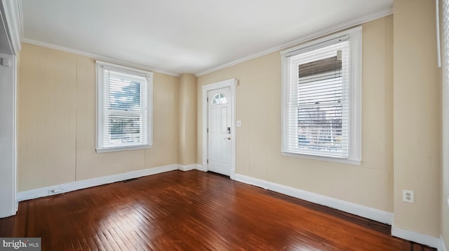 entryway with dark wood finished floors, a wealth of natural light, and crown molding