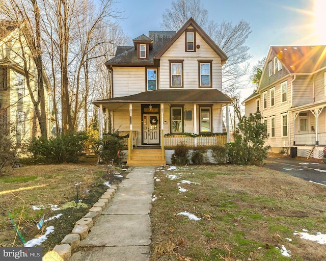 view of front of property with a porch and a front lawn