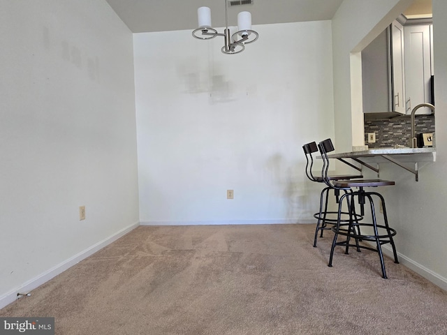 carpeted dining room with sink