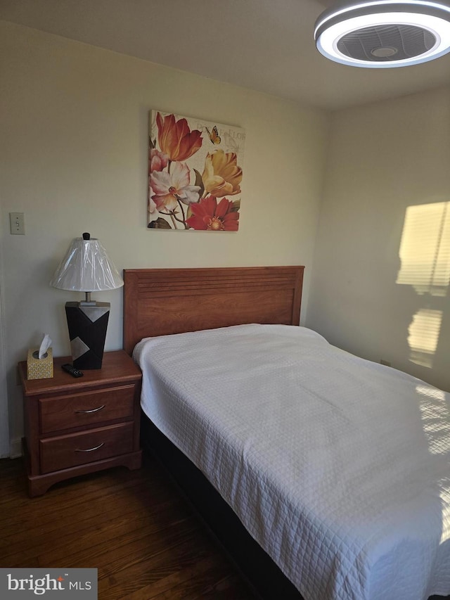 bedroom with dark hardwood / wood-style floors