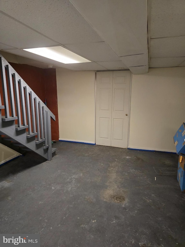 basement featuring a paneled ceiling