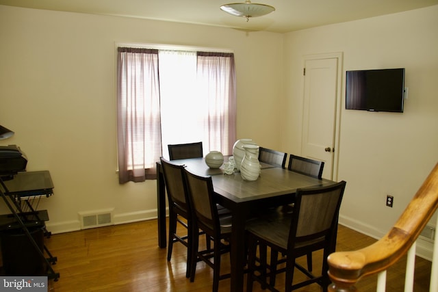 dining area with dark wood-type flooring