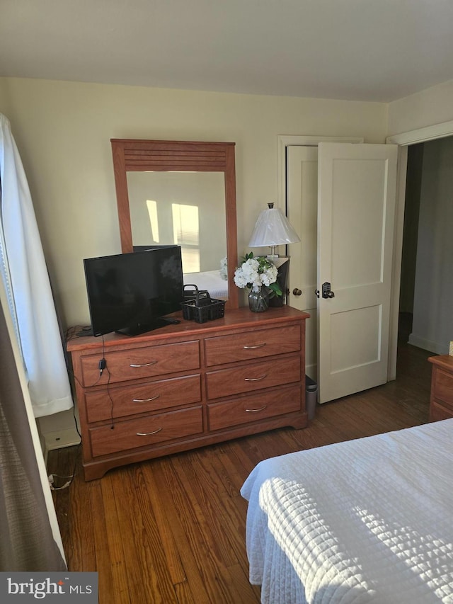 bedroom featuring dark hardwood / wood-style flooring