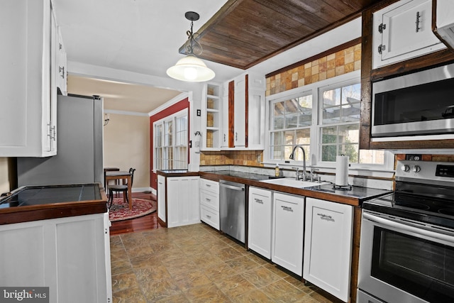 kitchen featuring sink, wooden ceiling, white cabinets, pendant lighting, and appliances with stainless steel finishes