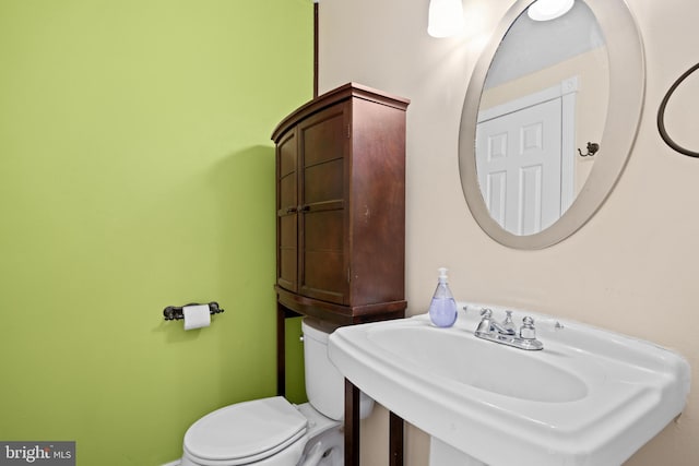 bathroom with toilet and sink