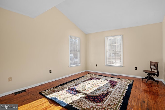 living area featuring hardwood / wood-style flooring and vaulted ceiling