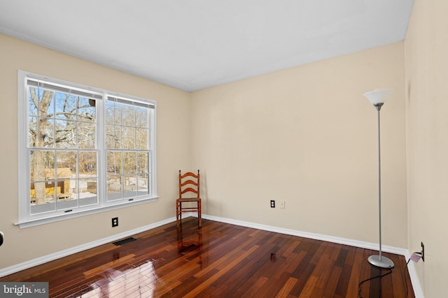 unfurnished room with dark hardwood / wood-style flooring