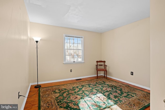 unfurnished room with hardwood / wood-style floors