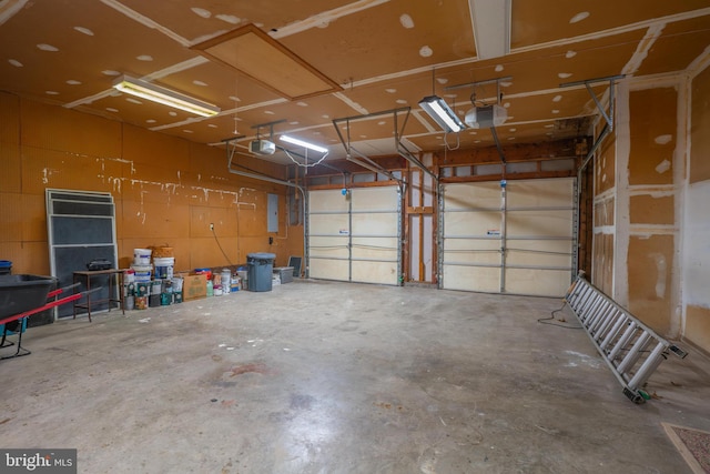 garage featuring electric panel and a garage door opener