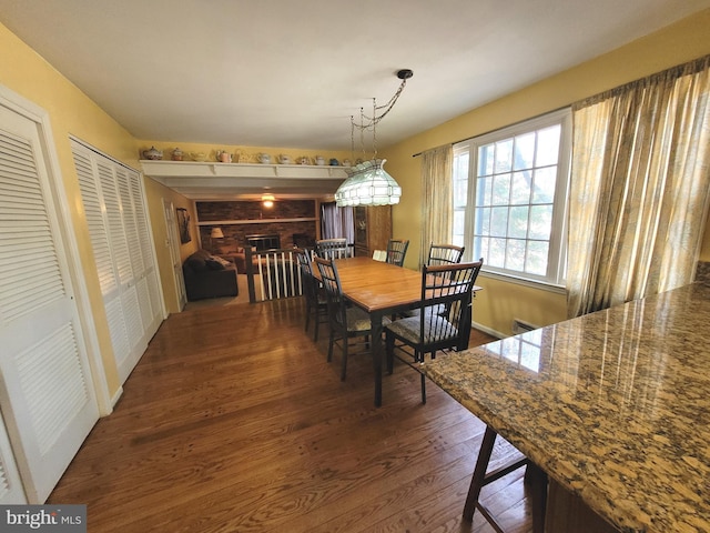 dining room with dark hardwood / wood-style flooring and an inviting chandelier