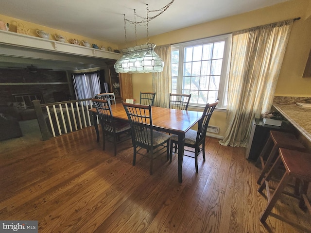 dining space with dark hardwood / wood-style flooring