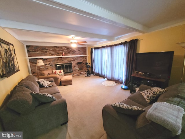 carpeted living room with ceiling fan, a brick fireplace, and beamed ceiling