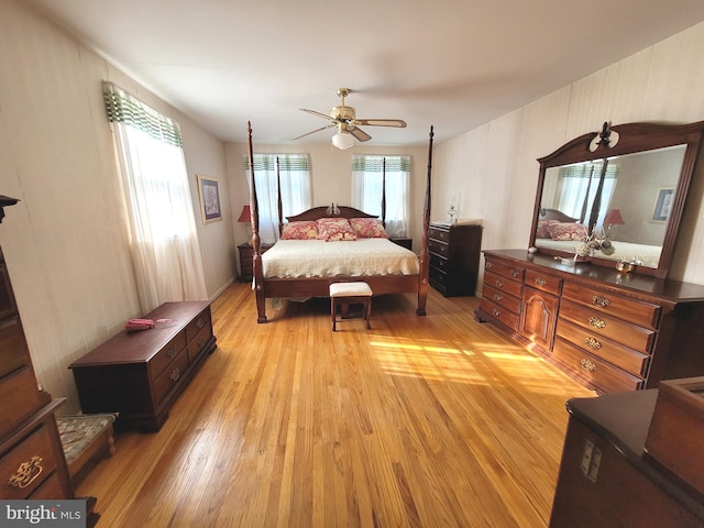 bedroom featuring light wood-type flooring, ceiling fan, and multiple windows