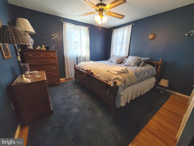 bedroom featuring dark wood-type flooring and ceiling fan