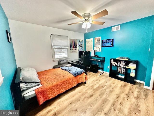 bedroom featuring ceiling fan and light hardwood / wood-style flooring