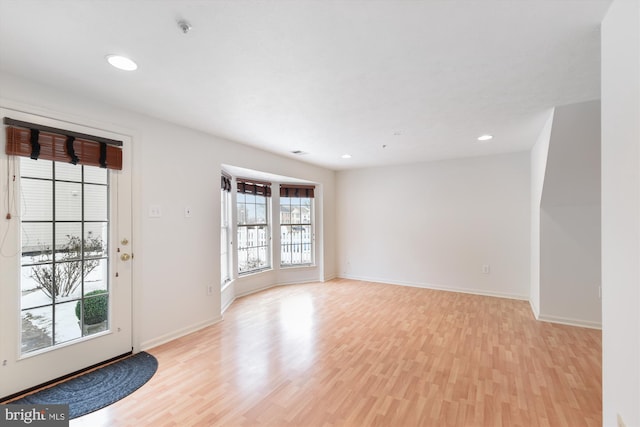 unfurnished room with light hardwood / wood-style flooring