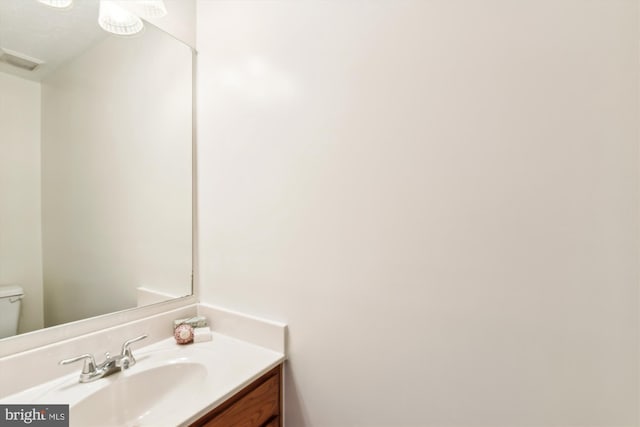 bathroom featuring vanity and toilet