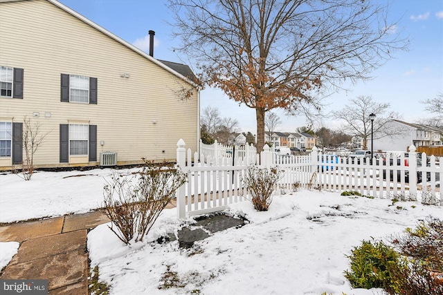 snowy yard with central AC unit