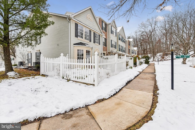 view of snow covered exterior featuring central AC