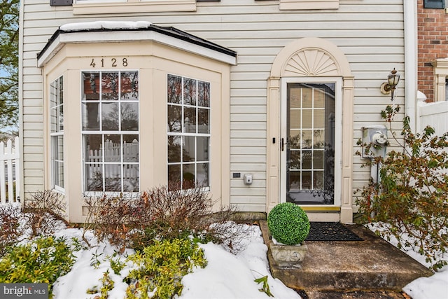 view of snow covered property entrance