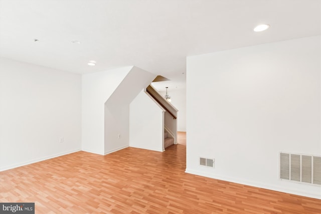 additional living space featuring light hardwood / wood-style flooring