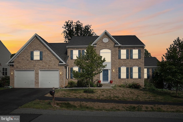 colonial inspired home featuring a garage