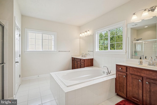 bathroom featuring tile patterned flooring, shower with separate bathtub, and vanity