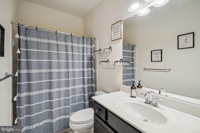 bathroom with vanity, toilet, and curtained shower