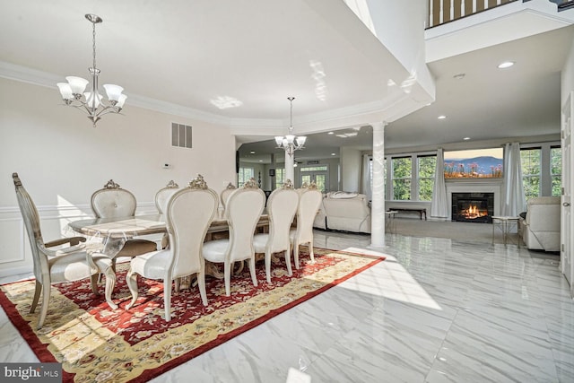 dining room with crown molding and a notable chandelier