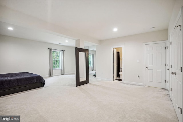 carpeted bedroom with ensuite bathroom