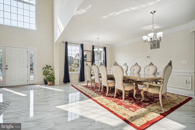 dining area featuring a chandelier and ornamental molding