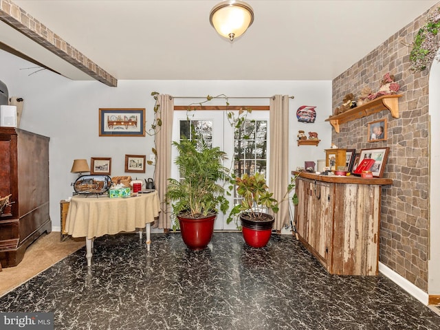 dining area featuring brick wall