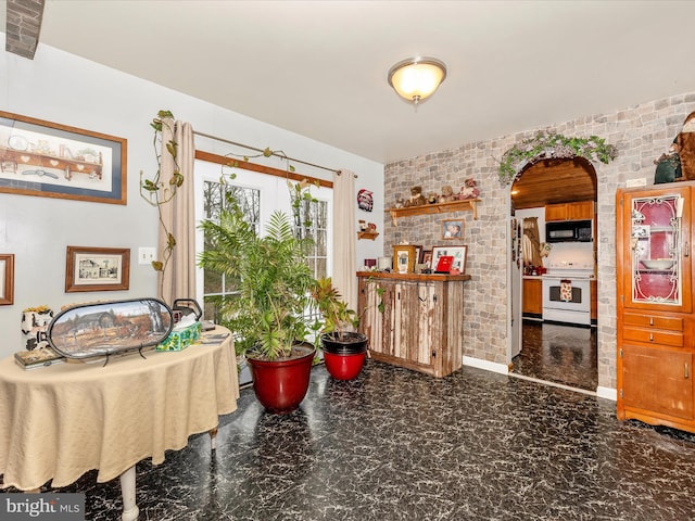 dining room featuring brick wall