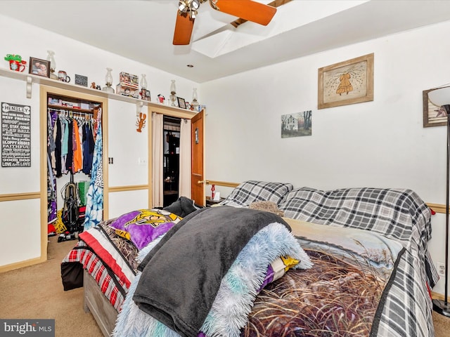 bedroom featuring ceiling fan, a closet, and light carpet