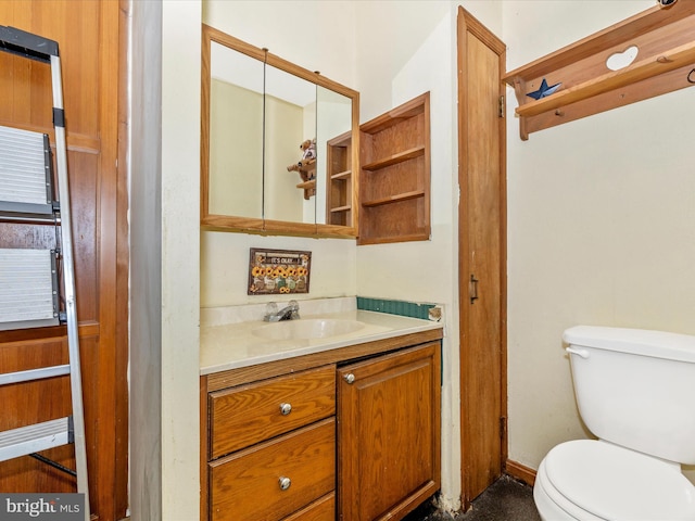 bathroom featuring toilet and vanity